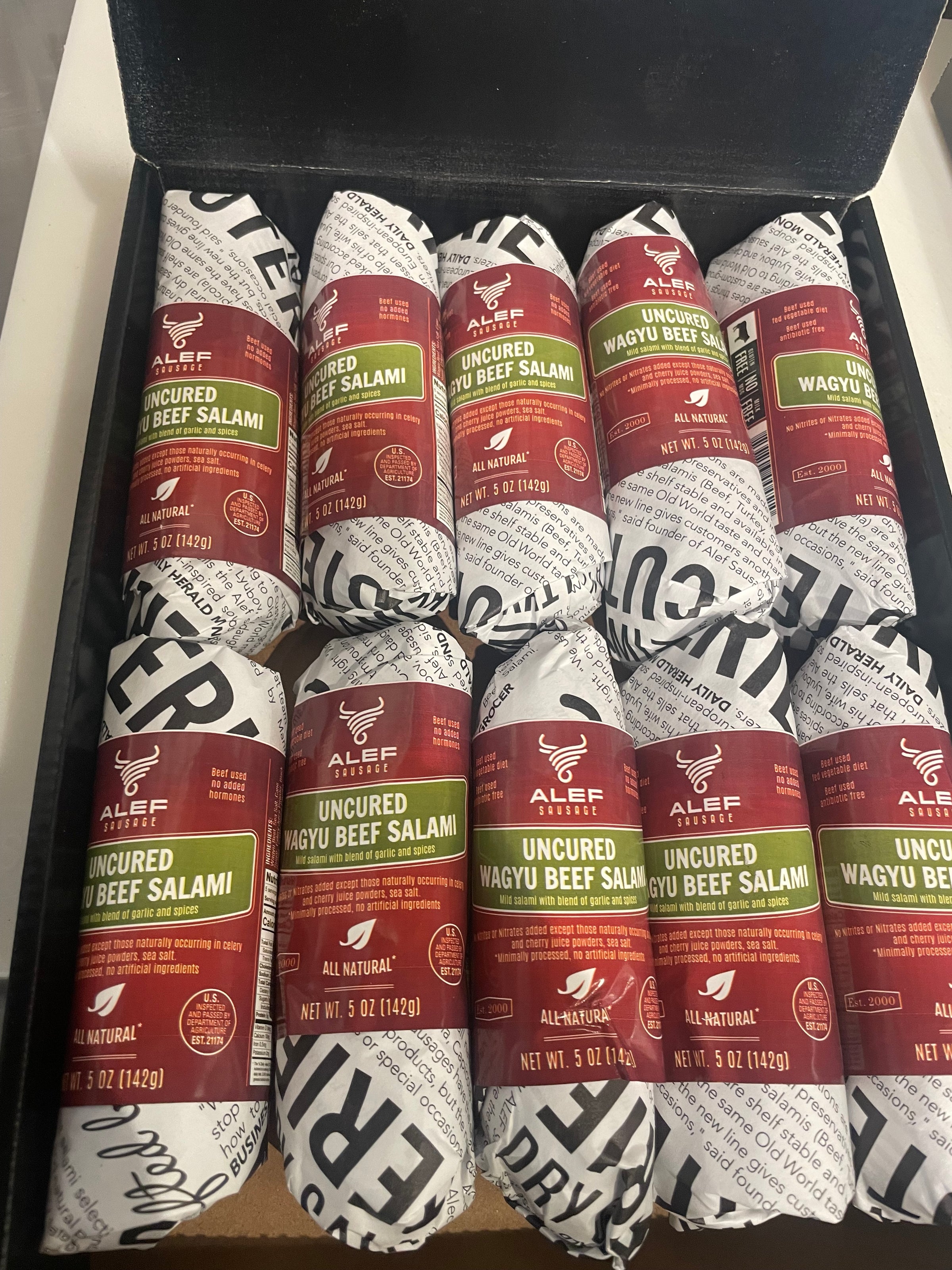 Box of sliced salami packages with visible branding