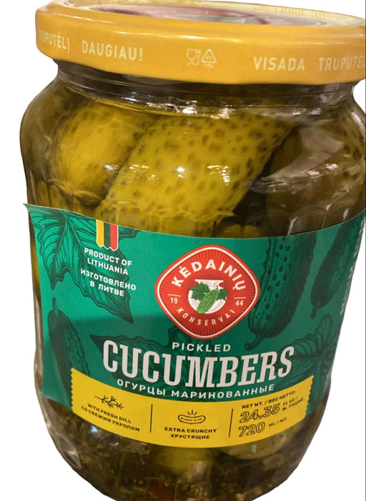 Jar of pickled cucumbers with a green label on a metallic surface