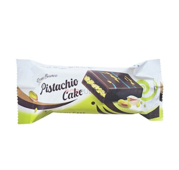 A packaged Pistachio Cake bar by Ricolino, shown in its white and lime green wrapper with an illustration of the chocolate cake bar.