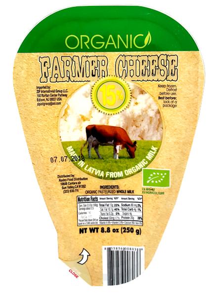 Packaging of organic farmers cheese showing the label with the brand, product name, weight, and an image of a cow, indicating it is made from organic milk.