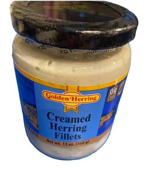 Jar of Golden Herring Creamed Herring Fillets on a blue surface