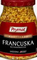A jar of Prymat French mustard, mild, with visible mustard seeds and labeled in Polish.