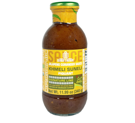 Bottle of S.A.C.E. hot sauce with a yellow label on a white background