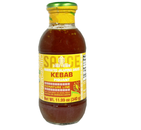 Bottle of Kebab sauce with a yellow label on a white background