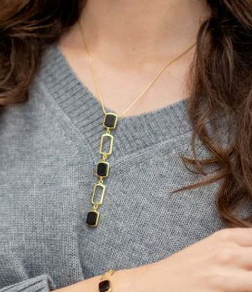 Long, slender necklace made of dark cherry amber