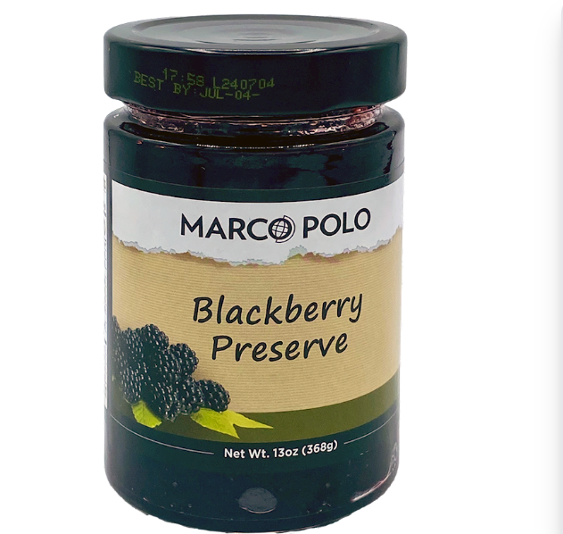A jar of Marco Polo Blackberry Preserve on a plain white background. The jar has a dark green lid and a label with a beige center and green and black graphics.