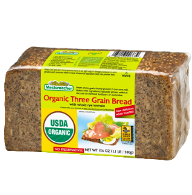 Block of organic three grain bread with a label on a white background