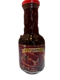 A bottle of NATURE'S BEST Organic Pomegranate Juice, 250ml, not from concentrate.