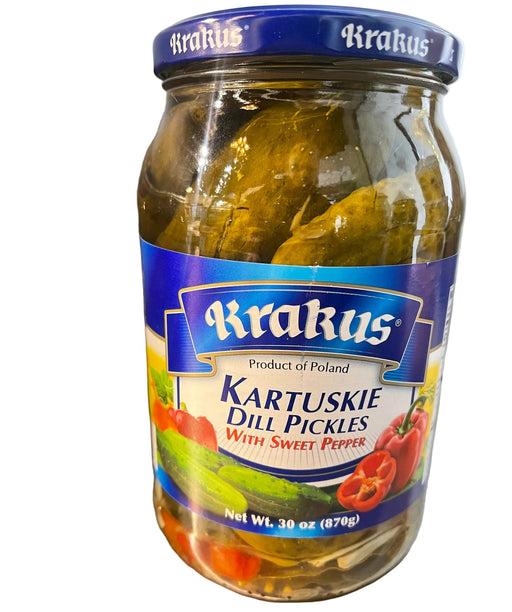Jar of Krakus dill pickles on a metallic surface