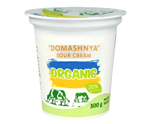 Container of Domashnya organic sour cream on a white background