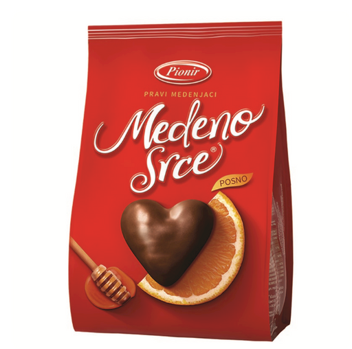A red bag of Pionir Medeno Srce posno chocolate, featuring a heart-shaped chocolate and an orange slice on the front, with the brand name Pionir and product name Medeno Srce clearly visible.