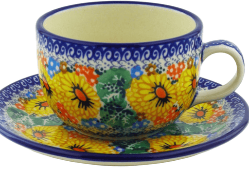 Colorful ceramic cup and saucer with floral design on a white background