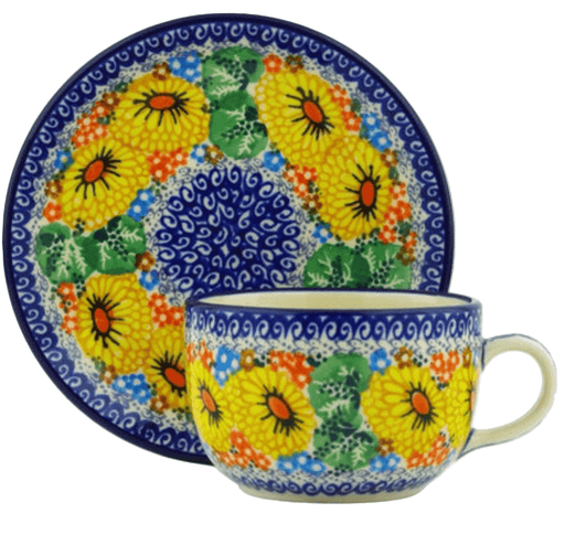 Ceramic cup and saucer with colorful floral design on a white background