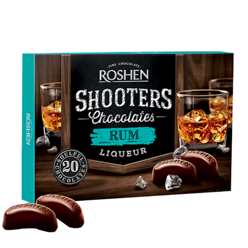 Box of Roshen Shooters Chocolates Rum Liqueur with chocolate shots on a wooden surface.