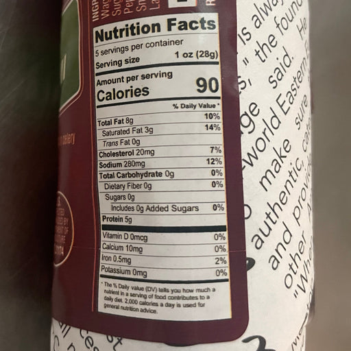 Rolled-up food product with label on a gray surface