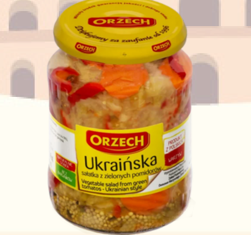 Jar of Orzech Ukrainian-style vegetable salad with a yellow lid and label.