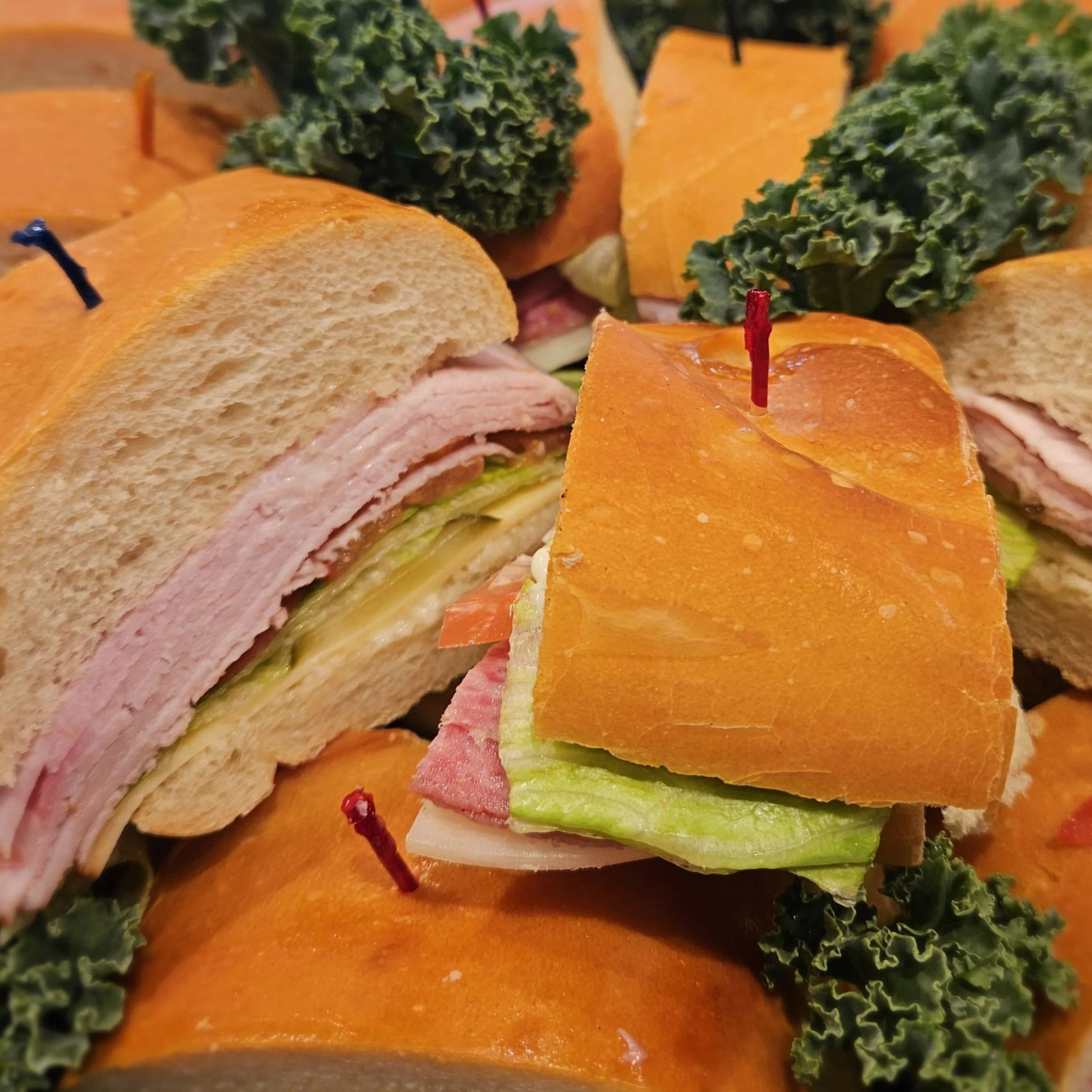 sandwiches with ham, lettuce, and cheese on a tray