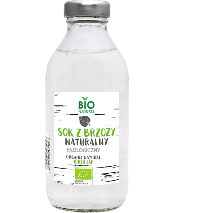 Clear glass bottle of organic natural birch sap with a label on a white background