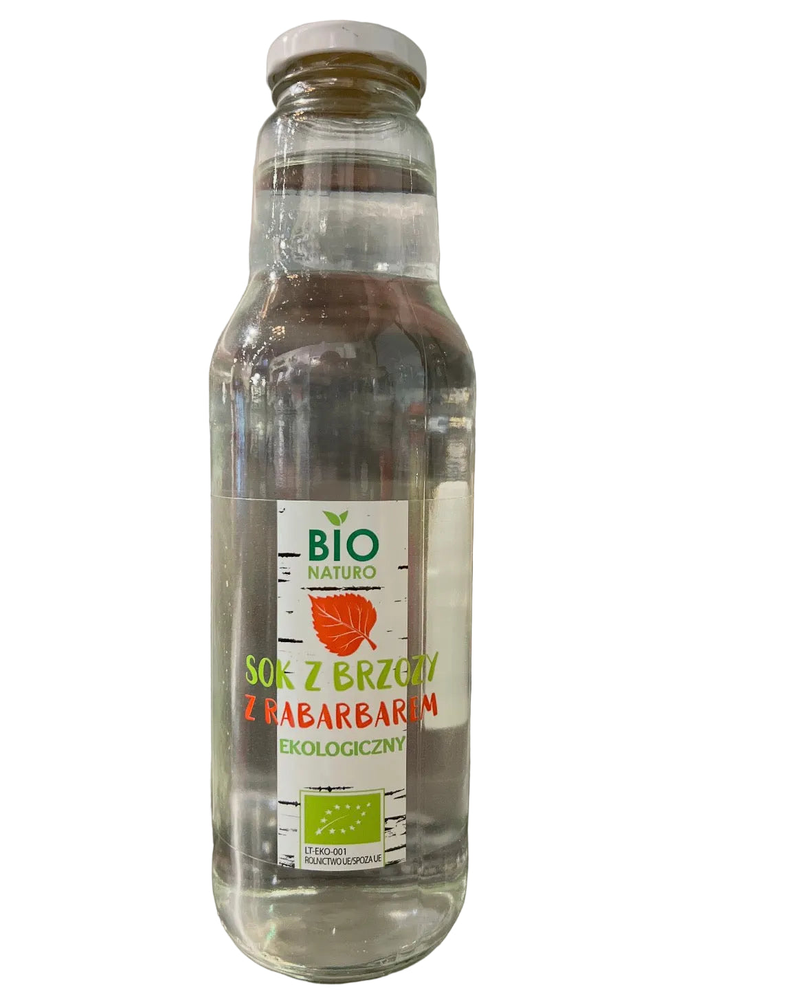 Clear glass bottle with a label on a reflective surface