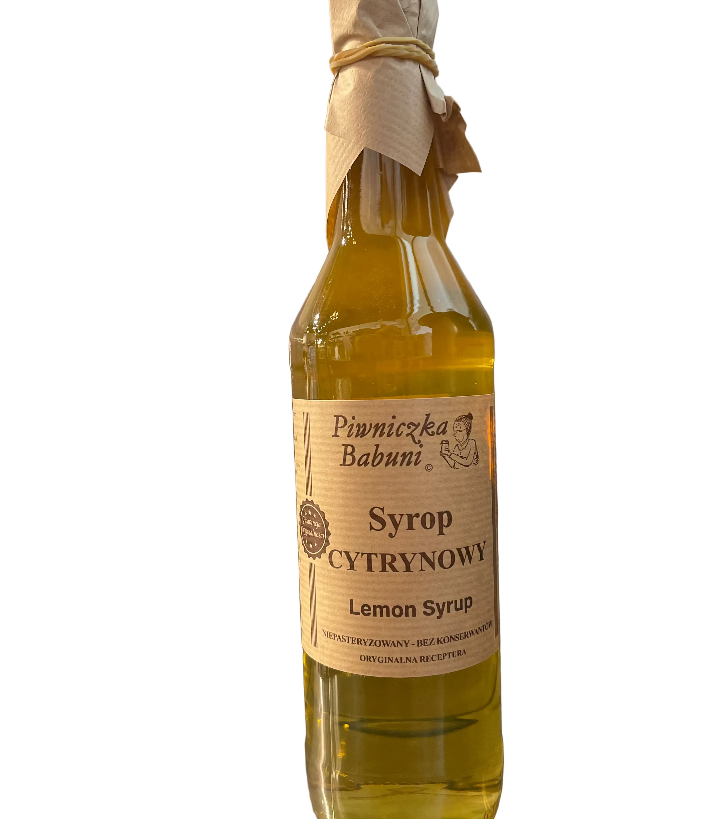 A glass bottle of lemon syrup with a beige paper label reading 'Pimnicęka Babuni Syrop Cytrynowy Lemon Syrup' and a cloth-wrapped stopper, set against a brushed metal background.