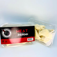 Packaged meat pierogi with a clear container on a light gray background