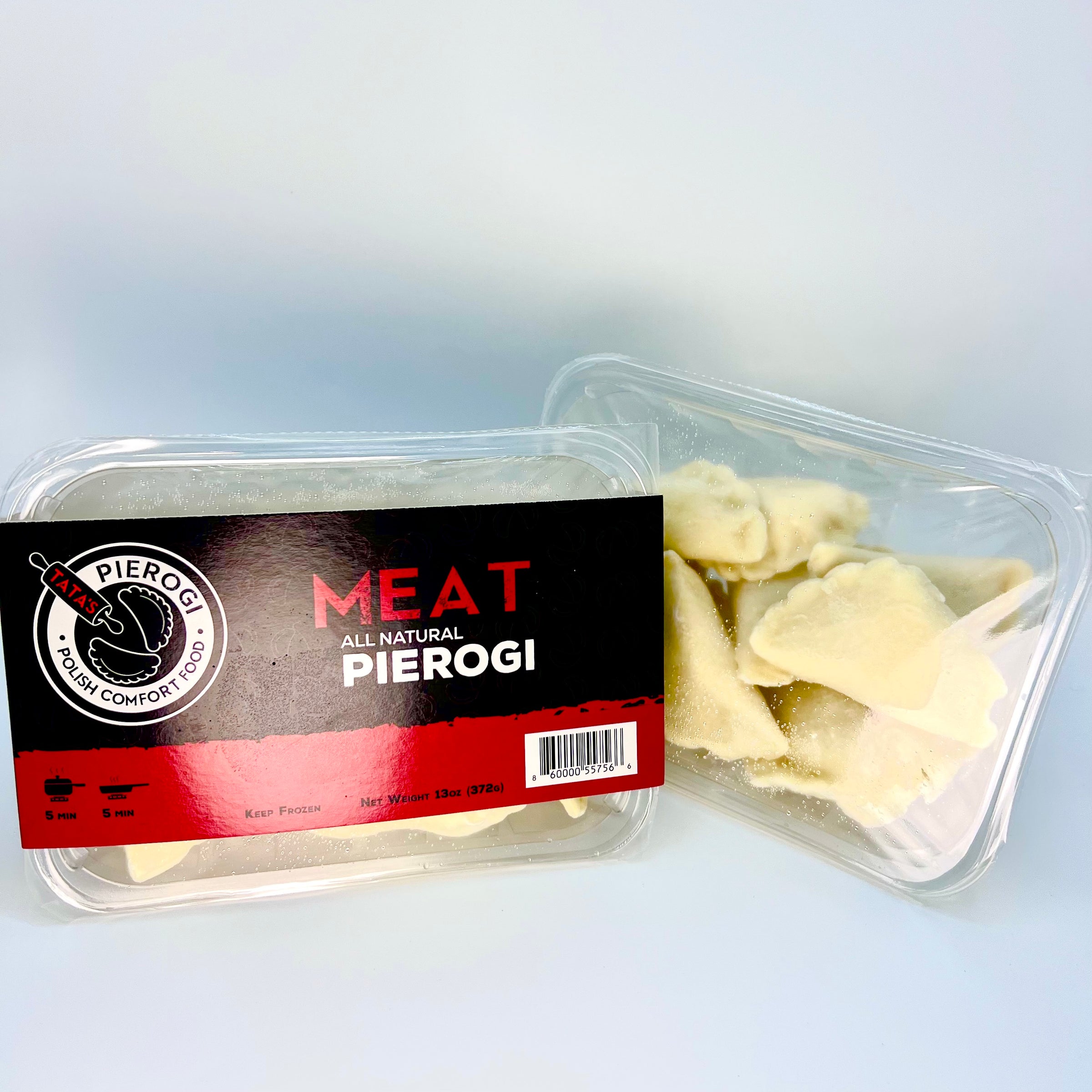 Packaged meat pierogi with a clear container on a light gray background