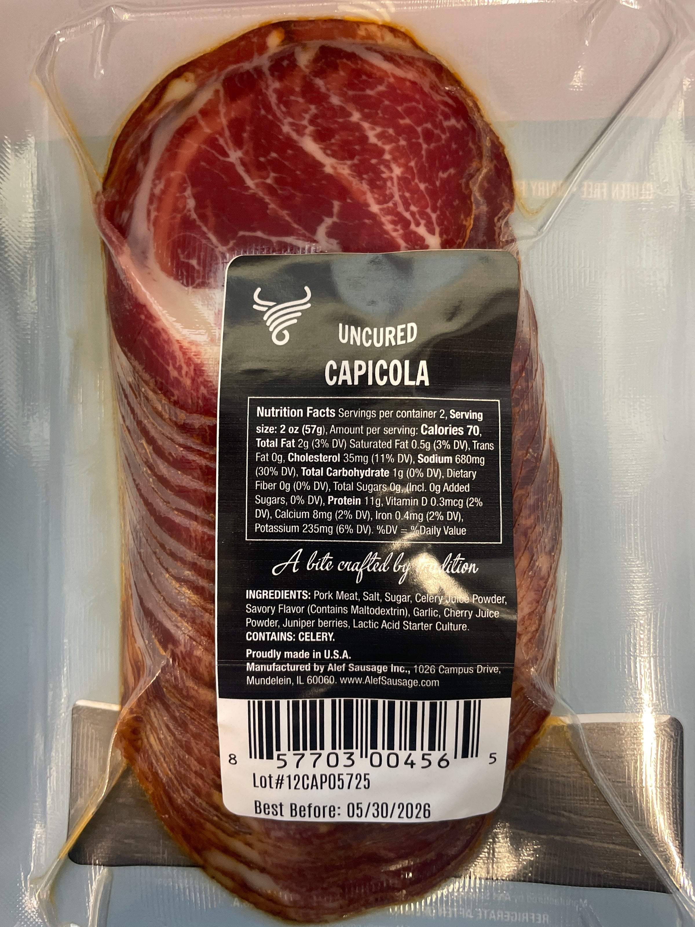 Packaged capicola with a label on a clear background