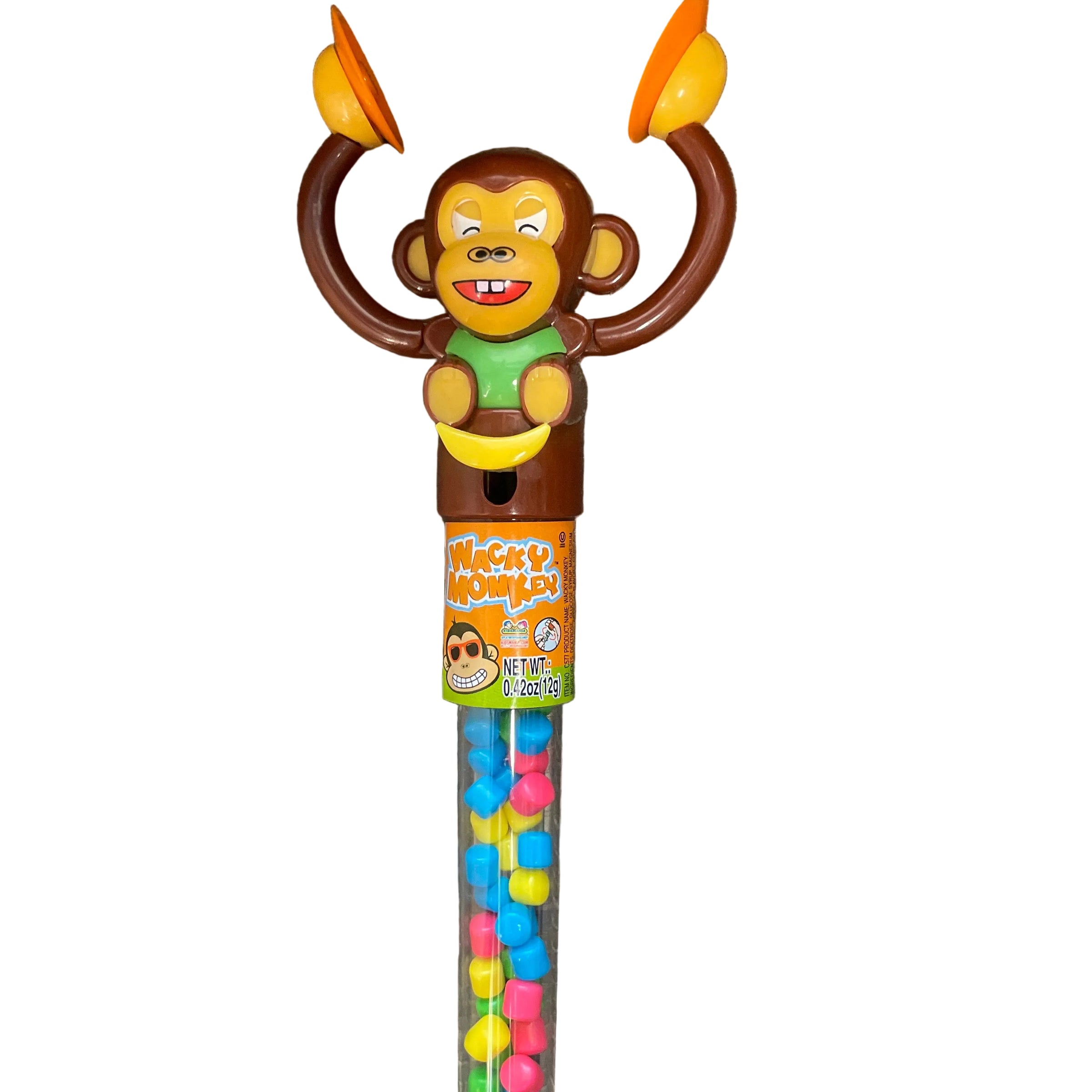 Monkey-shaped novelty candy tube with a smiling monkey head, orange juggling balls, and colorful round candies inside, photographed on a gray wood surface.