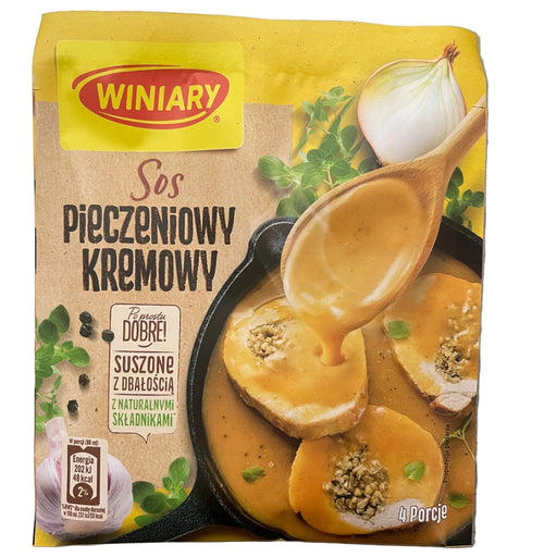 Packaging of Winiary creamy mustard sauce with a spoon and mustard balls on a gray background