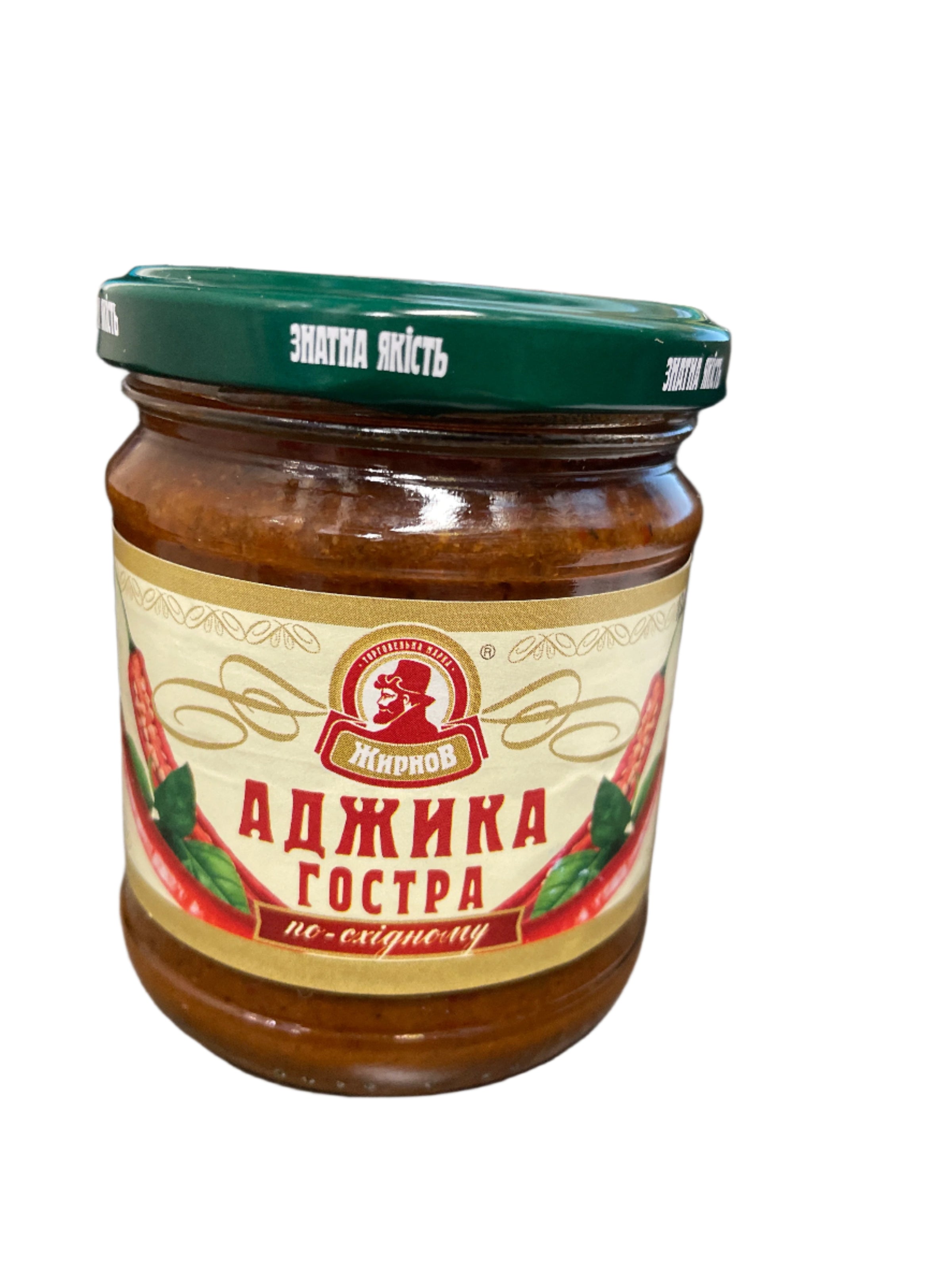 Jar of ajika with a label on a wooden surface