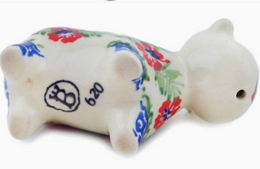 Ceramic piggy bank with floral patterns on a white background