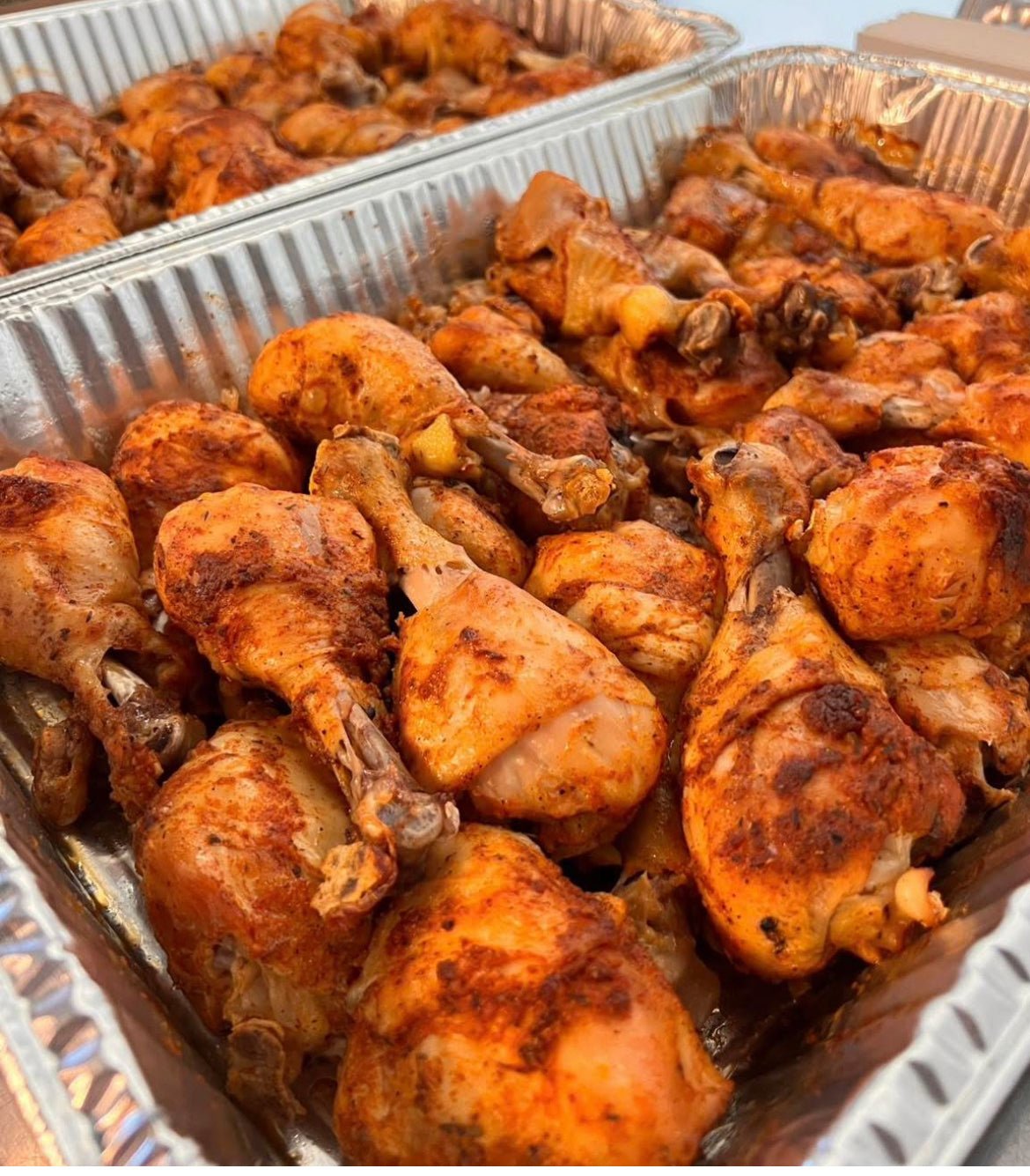 Baked chicken legs in a metal tray