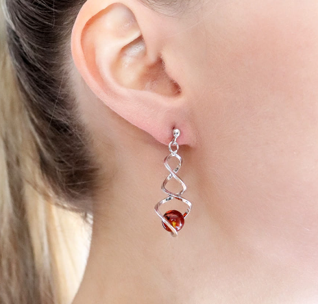 Very elegant hanging 925 silver earrings in the shape of a spiral with Baltic amber