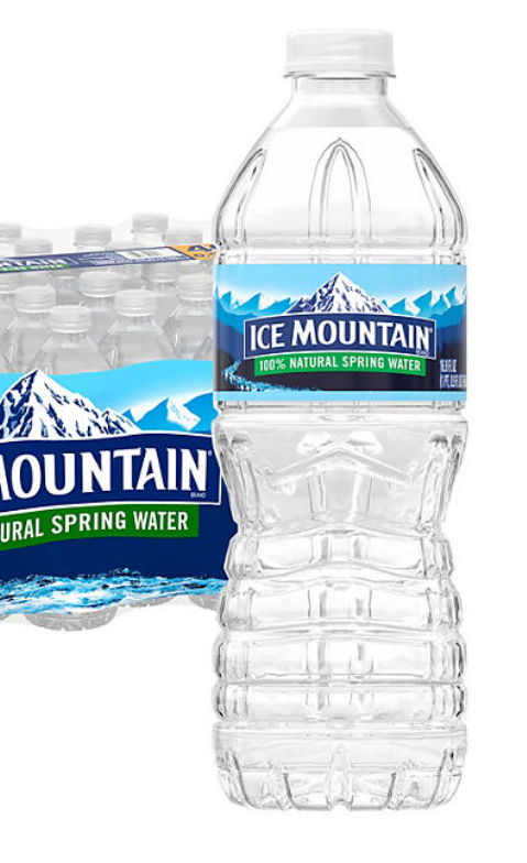 A plastic water bottle labeled 'ICE MOUNTAIN 100% NATURAL SPRING WATER', with a stack of similar bottles visible in the background.