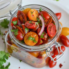 Juicy marinated cherry tomatoes European style served on plate