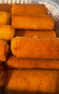 Stack of orange rectangular croquetes with mushrooms in a container